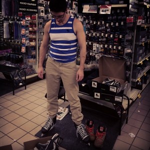 Me trying on skates, different size on each foot.